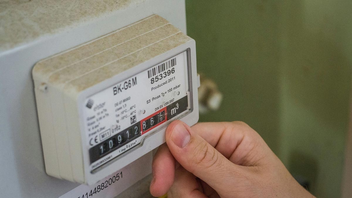 Nahaufnahme einer Hand, die einen Gaszähler abliest – symbolisch für Betriebskostenabrechnungen, die bei Auszug die Höhe der Kautionsrückzahlung beeinflussen können.